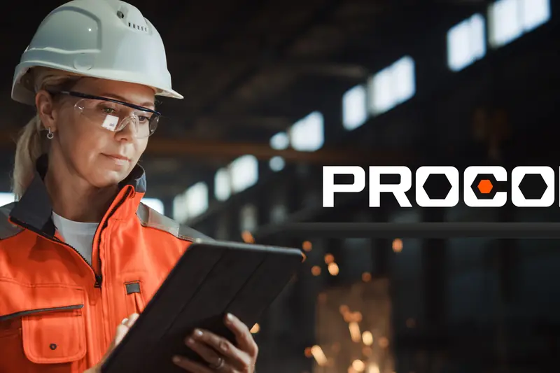 Site engineer in a hard hat reviewing project data on a tablet