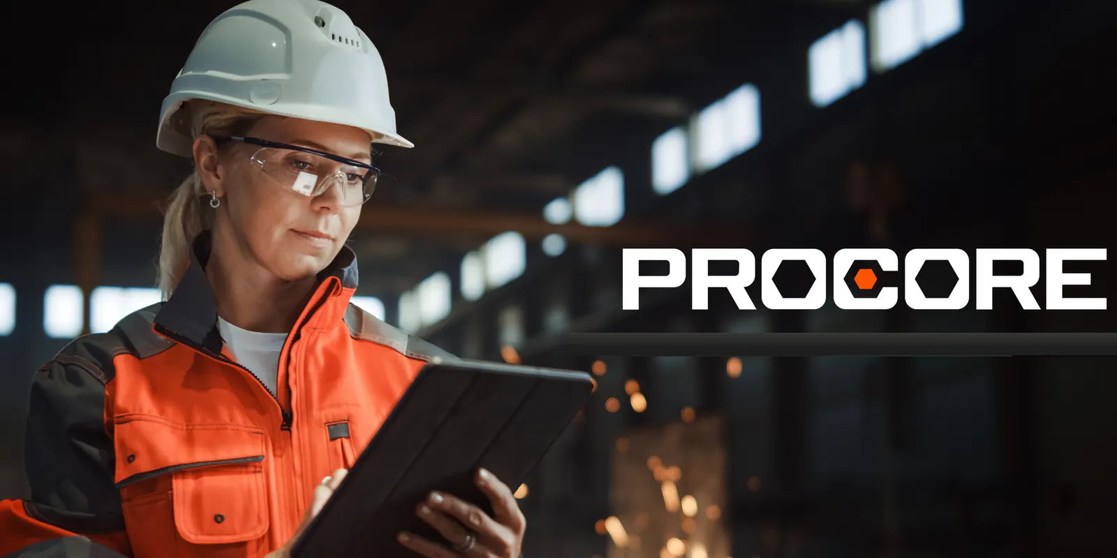 Site engineer in a hard hat reviewing project data on a tablet